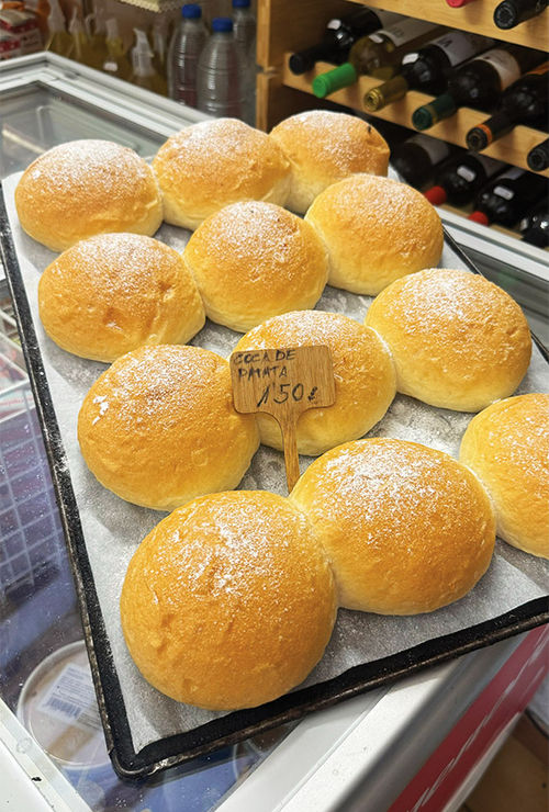 A tray of freshly baked coca de patata.