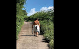 A young man brings his catch home, up a path on Hiva Oa.