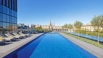 Le Meridien Melbourne's heated pool and deck is popular throughout the day. At night, the lights from the surrounding skyscrapers add to the magic