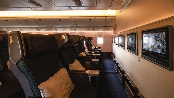 New premium economy seats feature larger seatback screens, leather headrests and footrests and wing extensions next to the headrest for privacy.