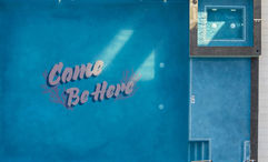 The pool at the Outrigger Waikiki Paradise Hotel been remodeled with a fun mural that reads “Come Be Here.”