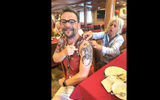 Passenger Thierry Bory shows off the tattoo he had inked aboard the ship.