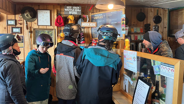 Skiers crowd into Corbet's Cabin at the top of Jackson Hole Mountain Resort for a snack.