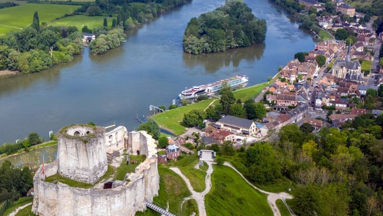 A Tauck riverboat docked near Chateau Gaillard on the Seine River.